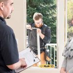 Renewal by Andersen employees speaking with a homeowner