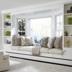 a bay window with pillows and a seating area