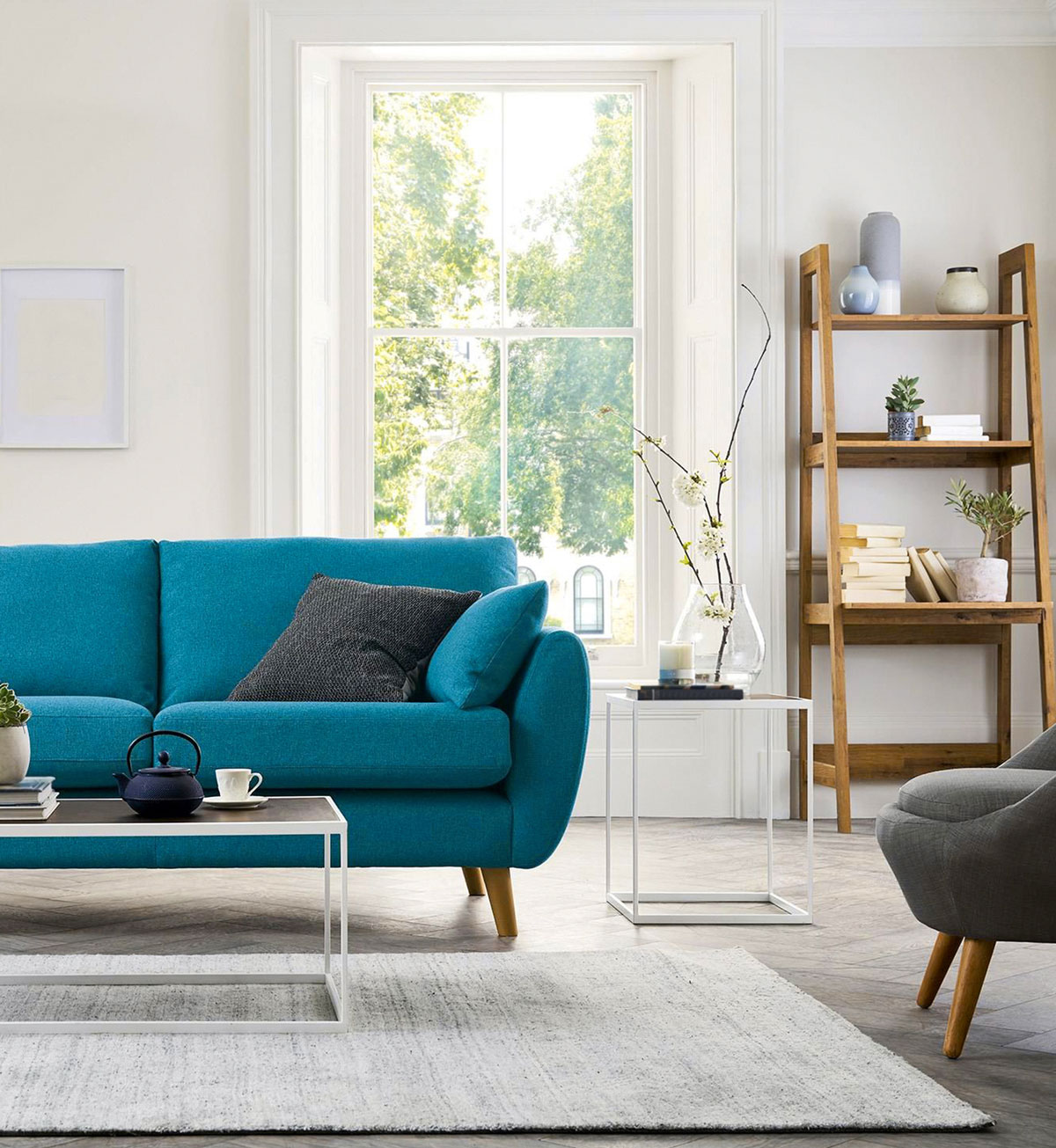 living room with blue couch and white window